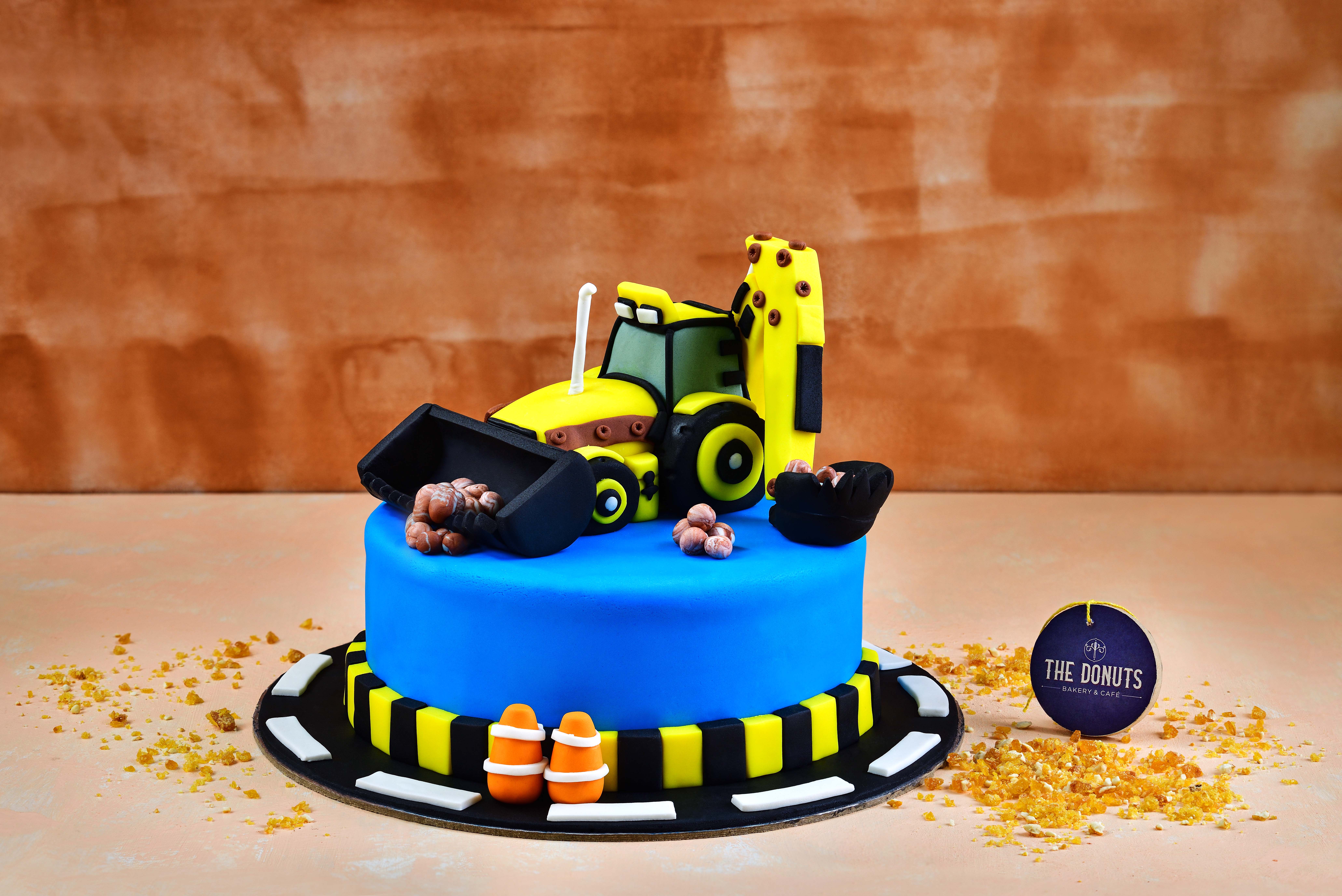 Cake Break - JCB theme chocolate kitkat cake with JCB toys... | Facebook
